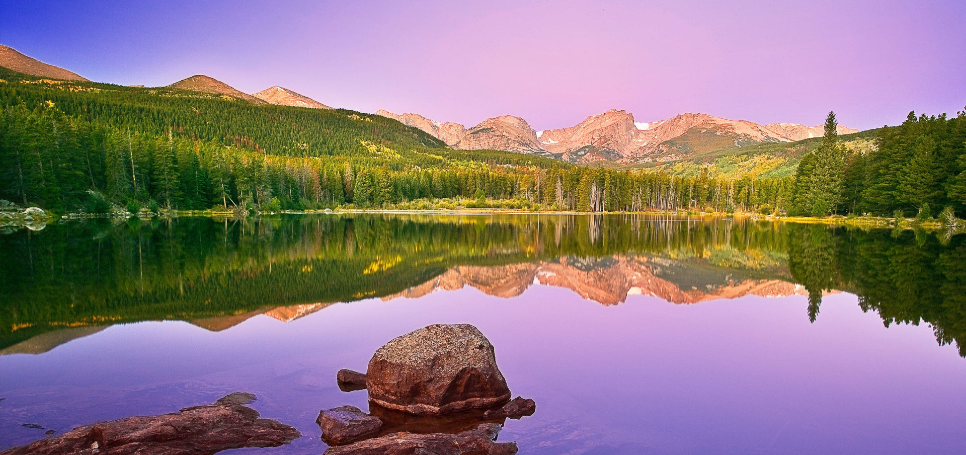 lake with forest and mountains in distance