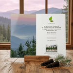 Card with mountain view and tree planting message on a wooden surface
